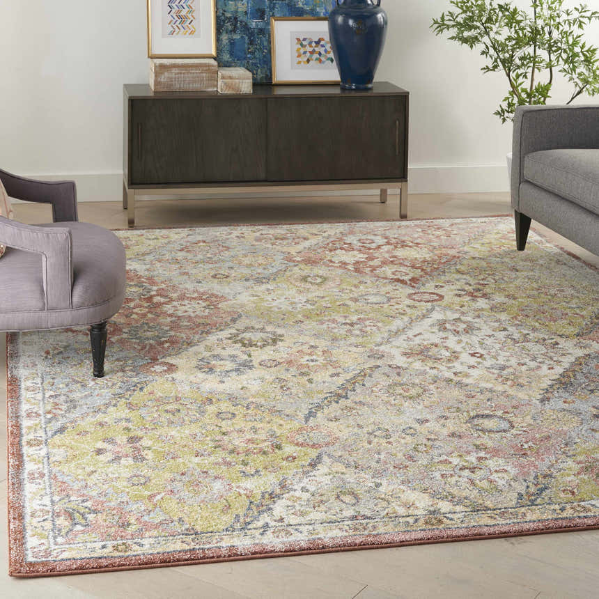 Living room scene with a Nourison Soraya Terracotta Multicolor rug, gray furniture, and a dark wood cabinet.