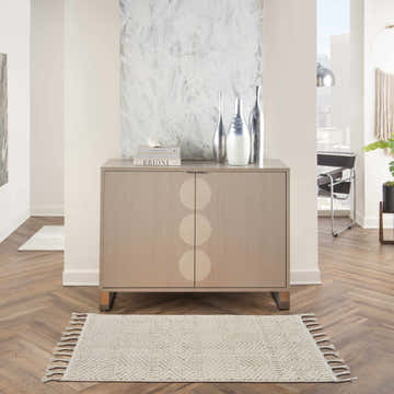 Modern hallway with Nourison Paxton Ivory rug, wood floors, and stylish cabinet.