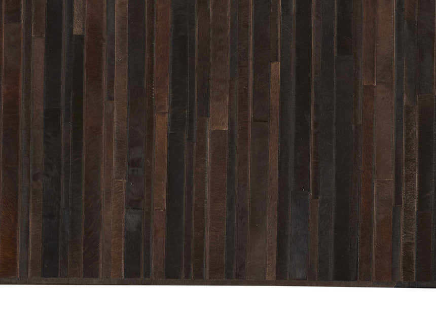 Close-up of the handmade Calvin Klein Home Prairie Sable rug. Sable-colored hair on hide strips create a textured, rectangular design.