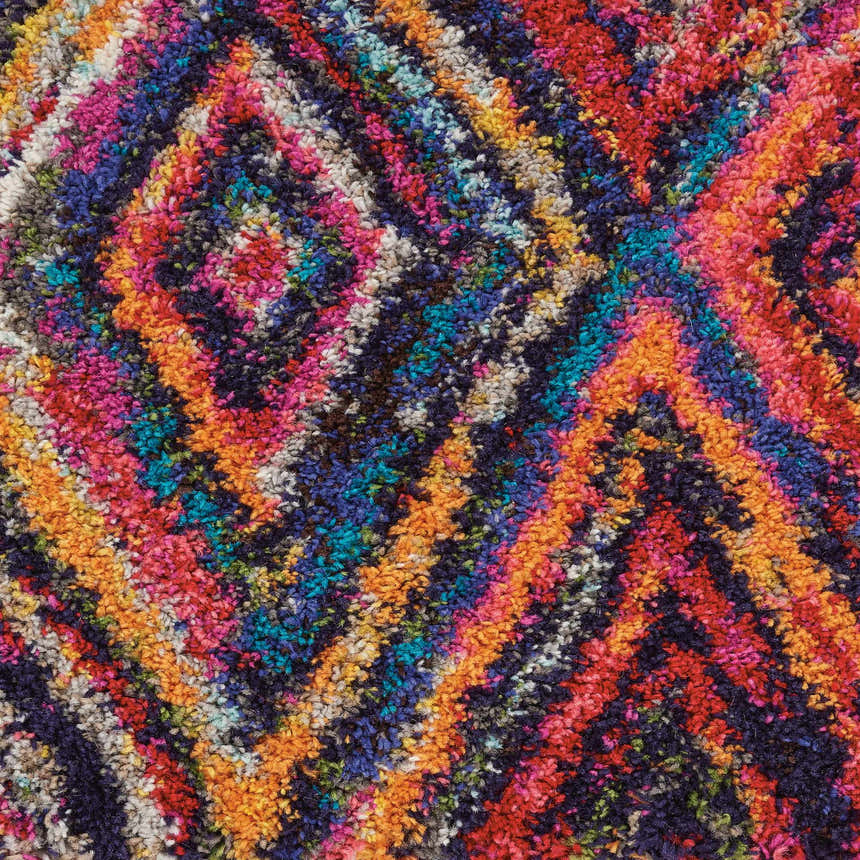 Close-up of the Nourison Nomad Red Multicolor Tribal rug, showing texture and vibrant diamond pattern.