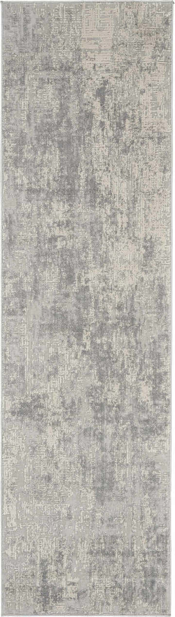 Close-up of the Nourison Rustic Textures Ivory/Silver area rug, showing its abstract, distressed pattern and soft texture.