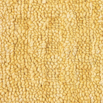 Close-up of the textured, gold pile of the Nourison Marana Gold contemporary wool rug.
