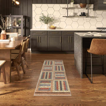 Multicolor Nourison Nordic runner rug in a modern kitchen with dark cabinets and wood floors.