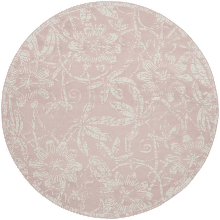 Close-up of a round Nourison Whimsicle Pink Farmhouse rug featuring a floral pattern in light pink and white.
