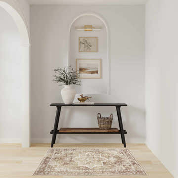 Entryway with black console table and Nourison Astra Rust Vintage Area Rug on light wood floor.