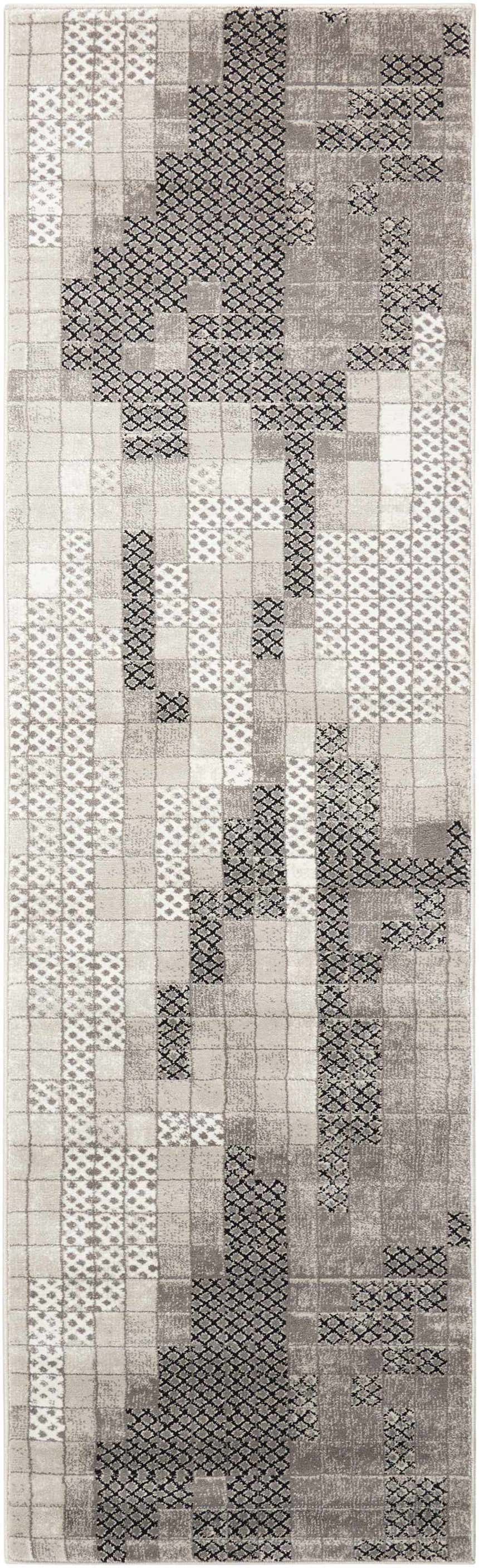 Close-up of the Nourison Soho Grey rug featuring a geometric pattern in shades of gray, black and white.