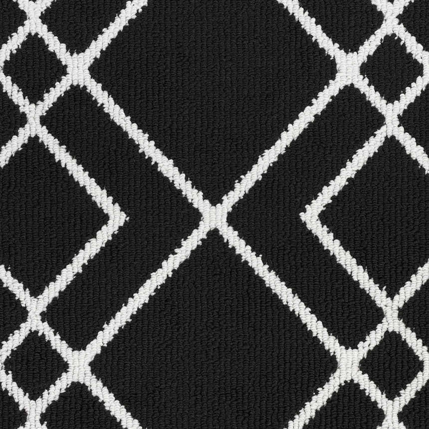 Close-up of the Nourison Modern Lines Black rug, featuring a geometric diamond pattern in white on a textured black background.