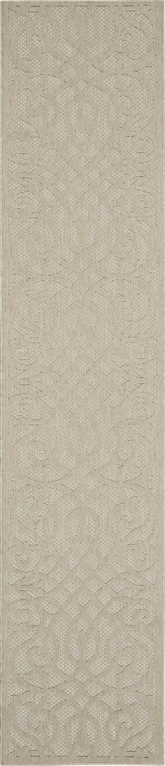 Close-up of the cream Nourison Cozumel Farmhouse area rug, featuring a subtle geometric pattern and textured weave.