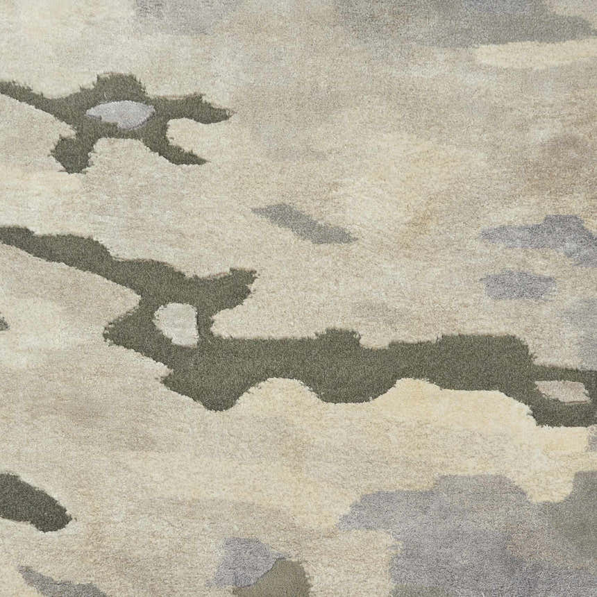 Close-up of the Nourison Prismatic Silver Cloud Rug. Abstract design in silver, cloud, and neutral tones. Soft, textured wool blend.