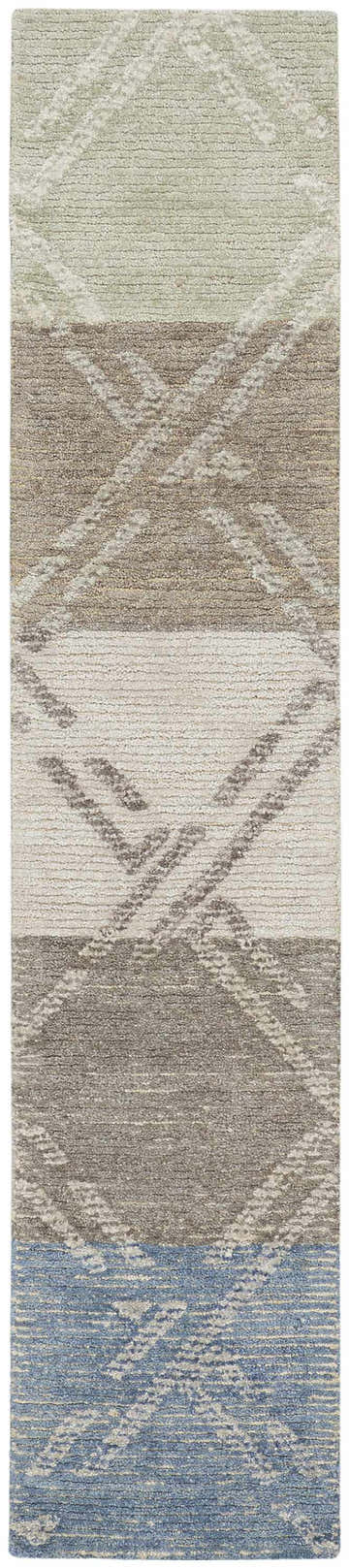 Close-up of Nourison Venosa rug. Modern design in green, ivory, taupe, grey, and blue with geometric diamond pattern. Handmade texture.