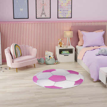 Pink kids room with Nourison Imagination Pink Kids Indoor Washable Area Rug, pink chair, and bed.