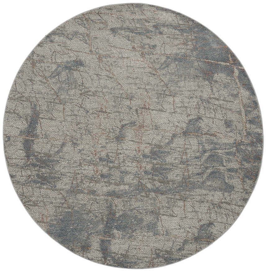 Close-up of round Nourison Rustic Textures rug. Light grey with blue and rust colored abstract pattern.