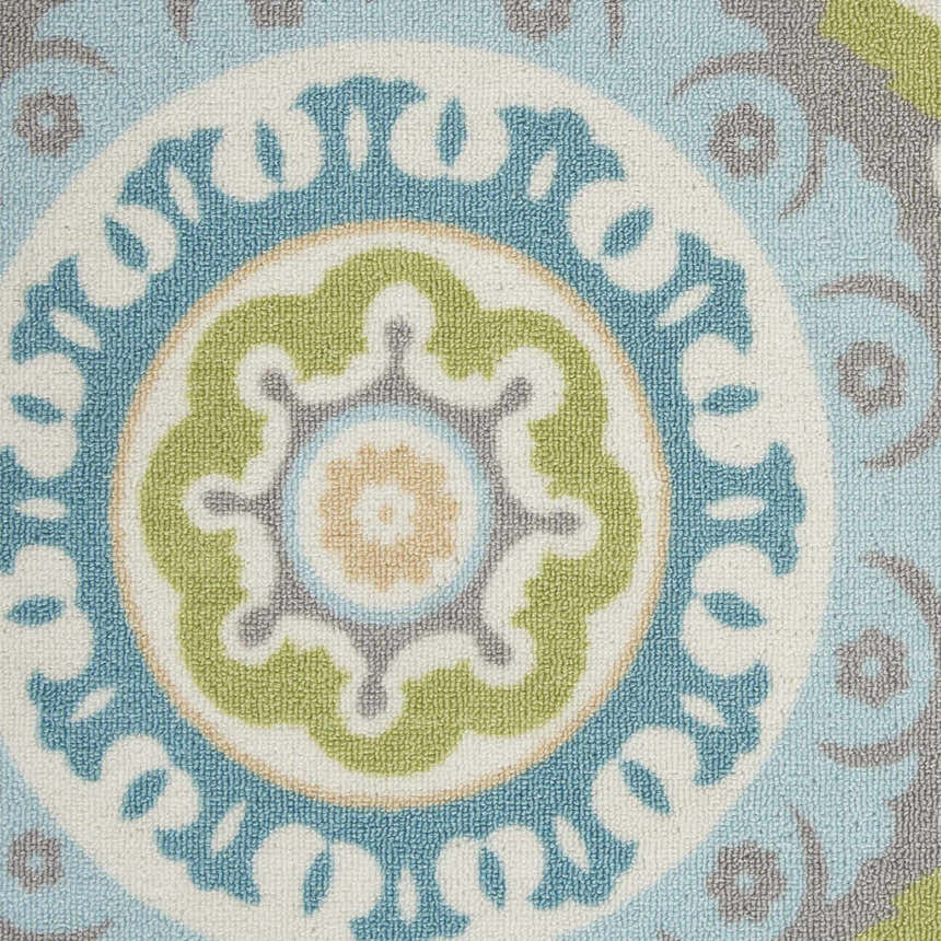 Close-up of Waverly Sun N' Shade Jade rug. Coastal style with a medallion pattern in jade, blue, green, and gray.
