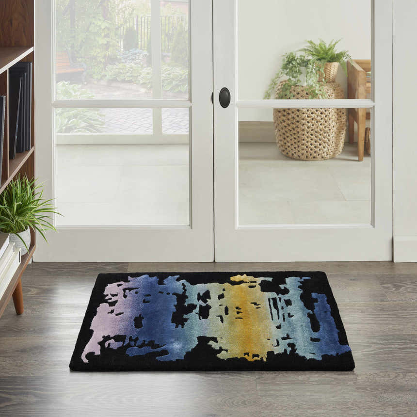 Entryway with Nourison Prismatic Black Multicolor rug. Modern design with blue, yellow, and black hues on wood floor.