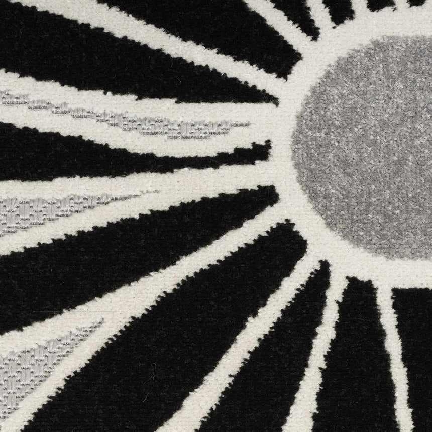 Close-up of the Nourison Aloha Black White Outdoor Area Rug featuring a geometric sunburst pattern.