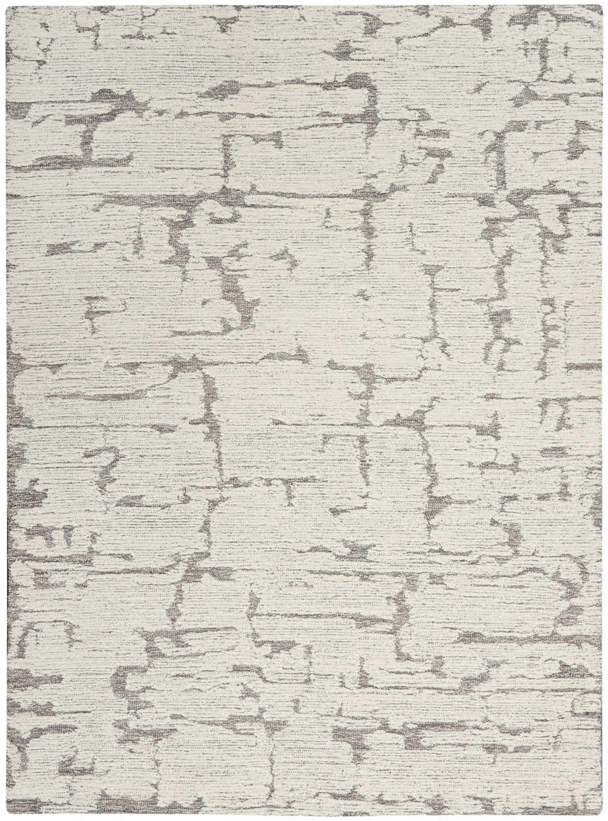 Close-up of the Calvin Klein CK009 Sculptural Grey rug. Modern design with a textured, abstract pattern in gray and white wool.