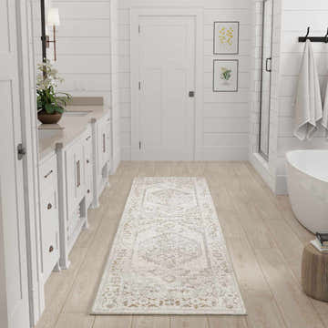 Bathroom scene with a grey vintage Nourison Astra runner rug on wood floors.