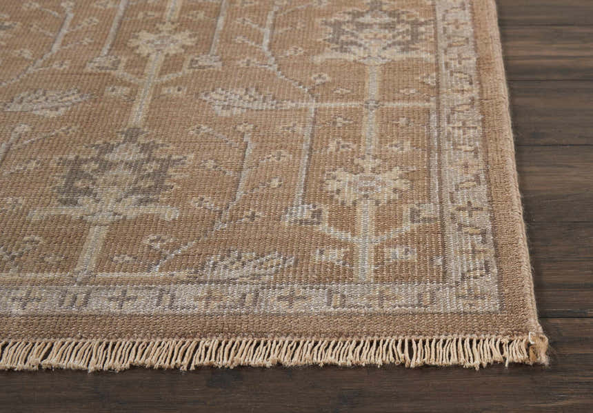 Close-up of the fringed Nourison Aldora Pewter rug showing its vintage floral pattern and bamboo silk-like texture.