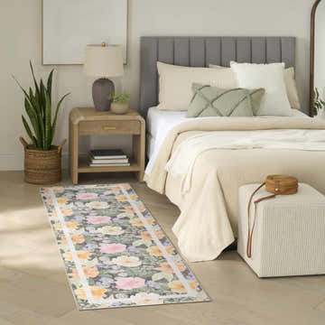 Farmhouse bedroom scene with Nourison Botanical Charcoal Multicolor runner rug, neutral bedding, and wood accents.