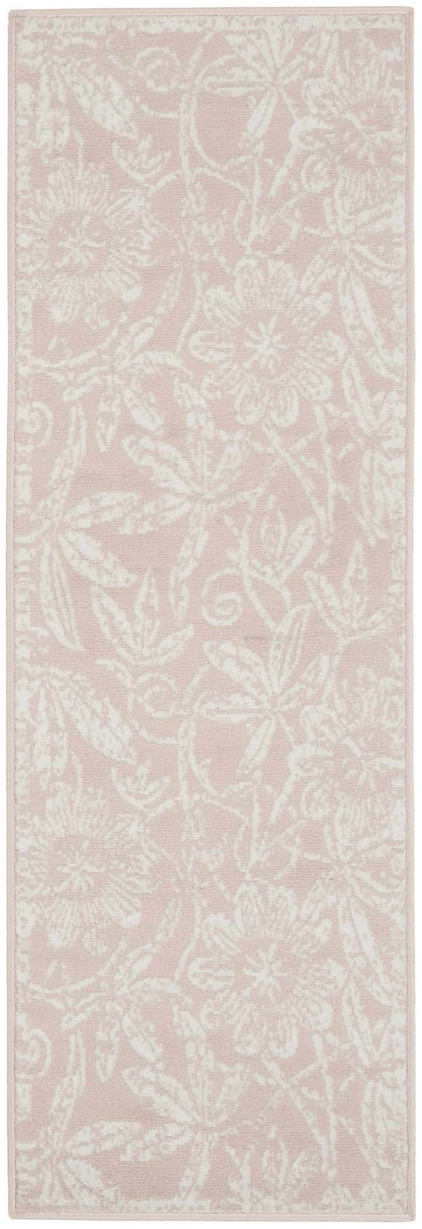 Close-up of the Nourison Whimsicle Pink Farmhouse Indoor Area Rug. Features a floral pattern in light pink and white.