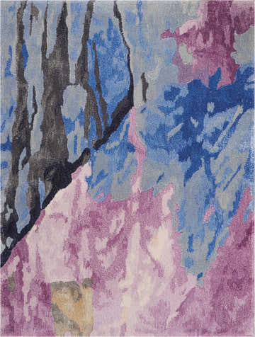 Close-up of the Nourison Prismatic Grey Multicolor rug. Abstract design with blue, gray, black, and pink hues. Handmade wool texture.