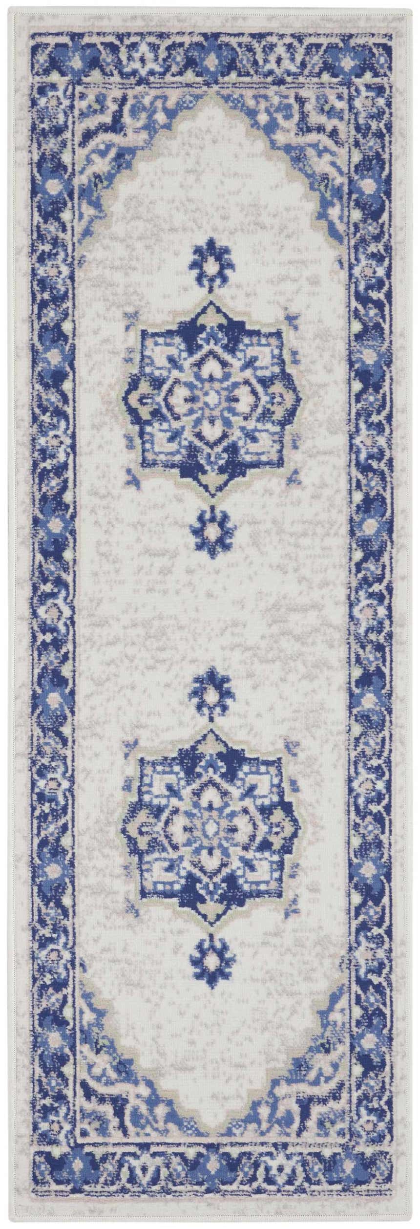 Close-up of the Nourison Whimsicle Ivory Blue rug, a farmhouse style runner with a blue floral medallion pattern.