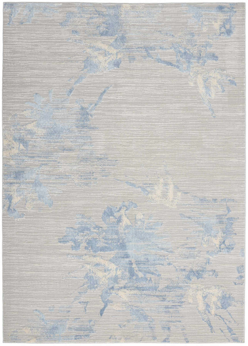 Close-up of the Calvin Klein CK005 Enchanting Grey Sky rug. Contemporary high pile rug with blue and cream abstract design.