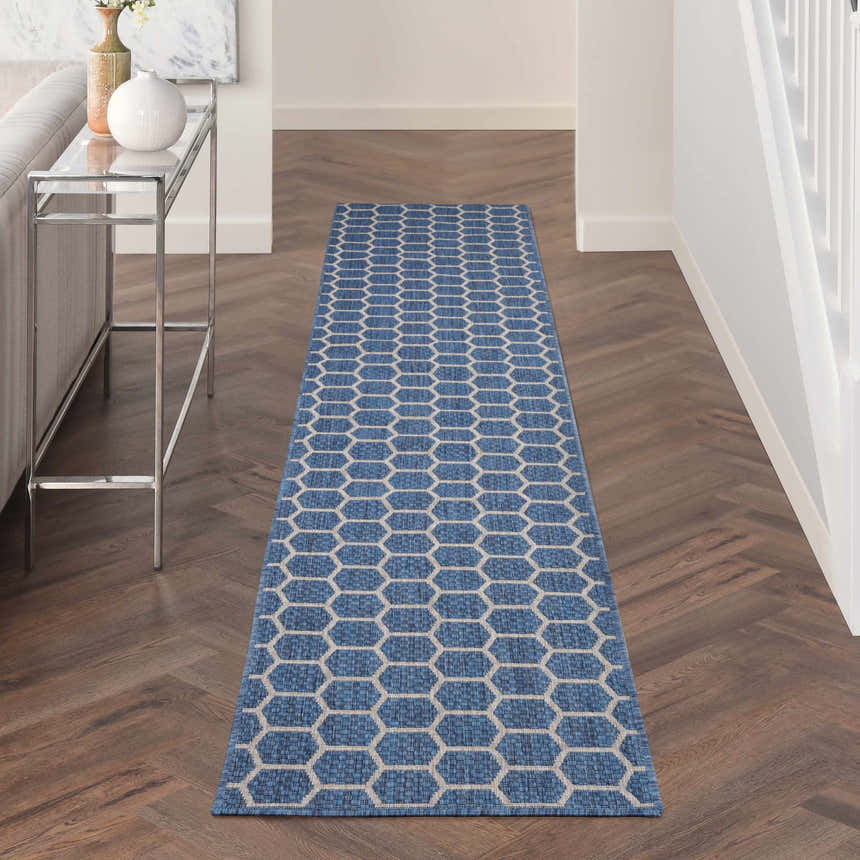 Hallway with Nourison Twist Reversible Blue Modern Area Rug runner, wood floors, console table, and bright, airy feel.