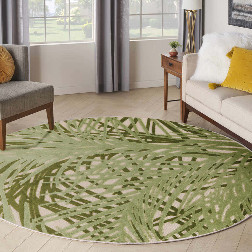 Living room scene with a round Nourison Aloha Ivory Green Outdoor Area Rug.