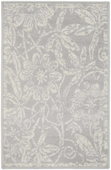 Close-up of a grey Nourison Whimsicle area rug with a subtle floral farmhouse pattern.