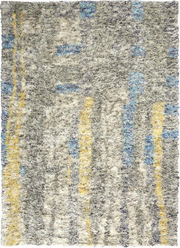 Close-up of the plush Calvin Klein San Antonio rug. Features a multicolor shag design with blue and yellow stripes on gray wool.