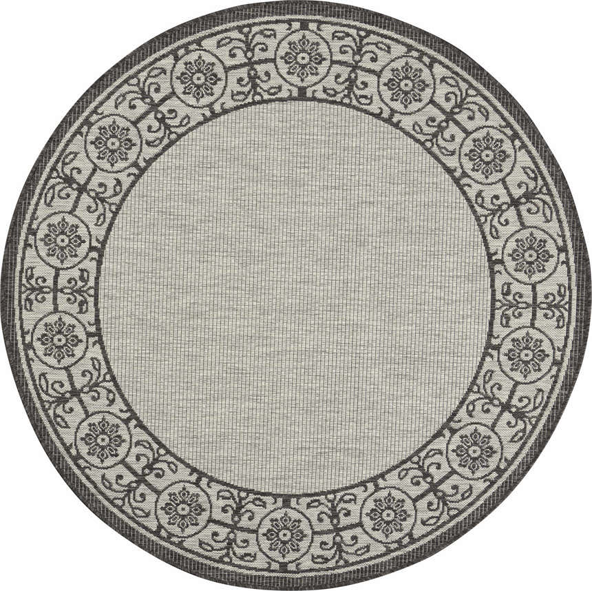 Close-up of round Nourison Country Side rug in ivory and charcoal. Features a floral and scroll border design.