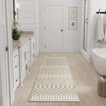 White bathroom with Nourison Astra Sage Bohemian runner rug on light wood floor.