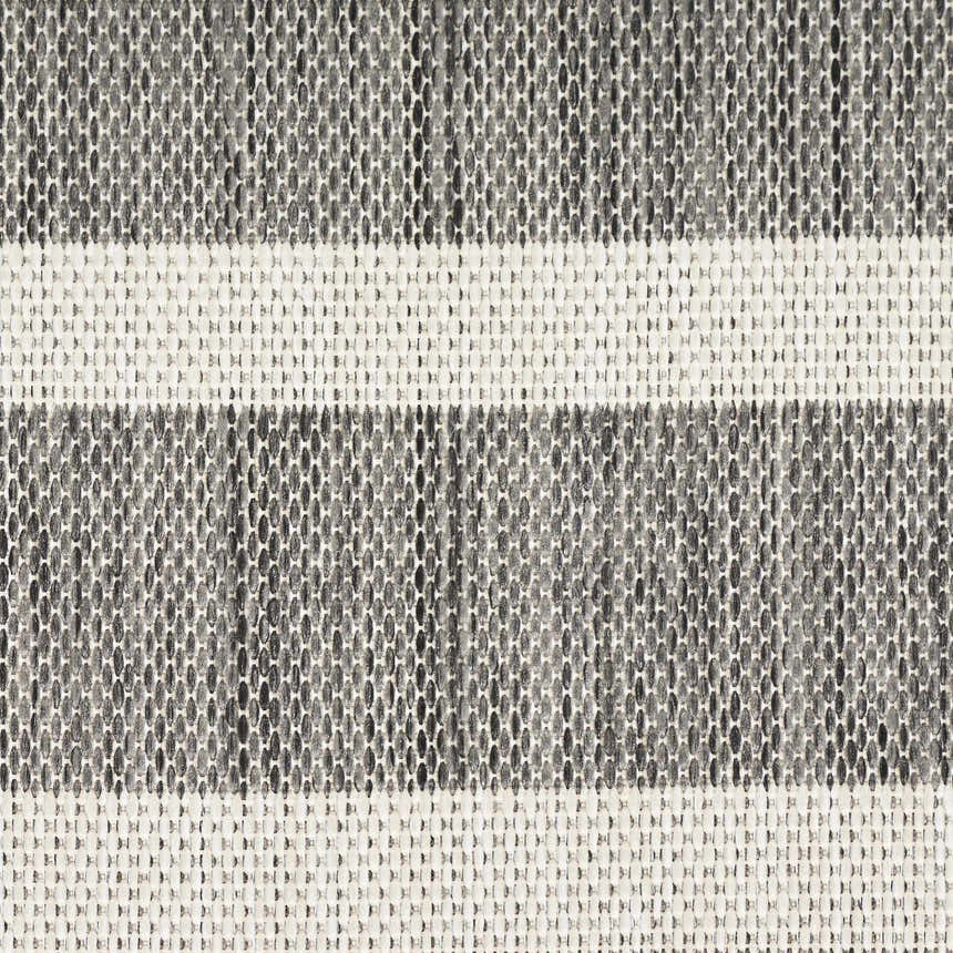 Close-up of the Nourison Positano Charcoal Ivory rug. Features a textured, woven design with charcoal and taupe hues.