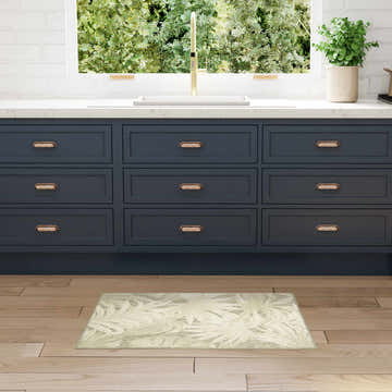 Kitchen scene with blue cabinets and Nourison Aloha Ivory Sage rug on wood floor.