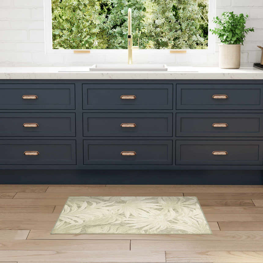 Kitchen scene with blue cabinets and Nourison Aloha Ivory Sage rug on wood floor.
