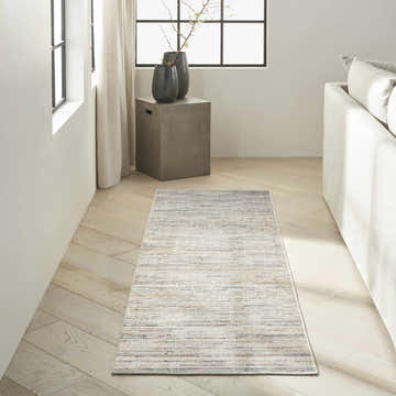 Modern living room with Calvin Klein CK078 Summit Ivory Multicolor rug, light wood floors, and neutral decor.