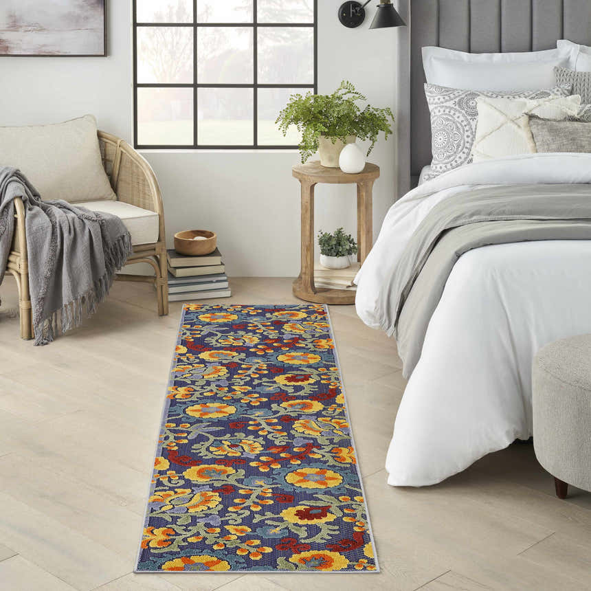 Bedroom scene with Nourison Aloha Navy Multicolor rug runner, floral pattern, brightening the neutral space.