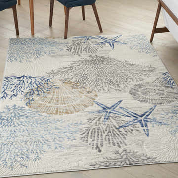 Close up of Nourison Seaside Ivory Grey Blue Coastal rug with starfish, coral, and seashell pattern.