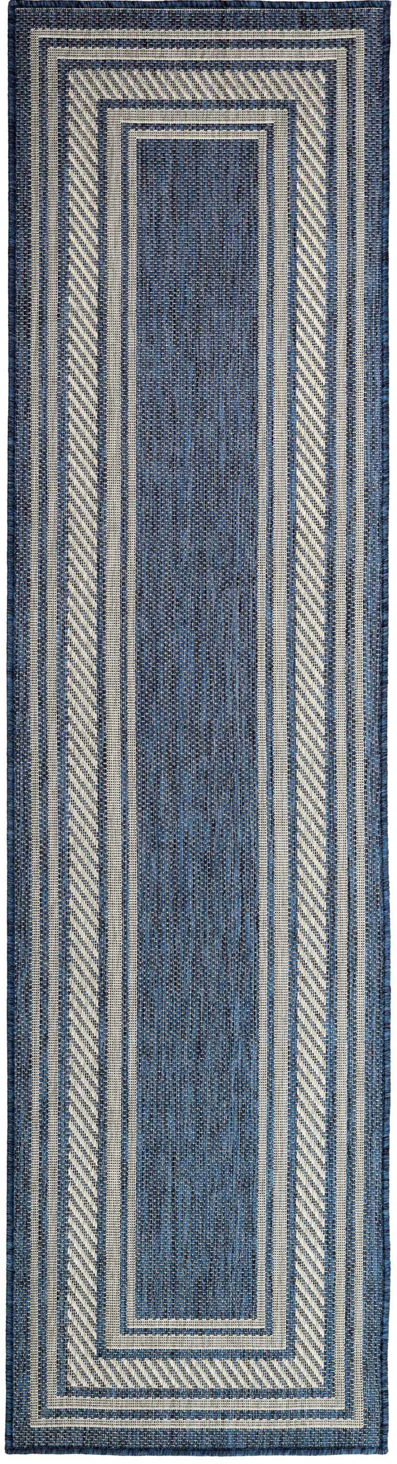 Close-up of the Nourison Horizon Denim rug. Features vertical stripes and a rectangular border in denim and off-white.