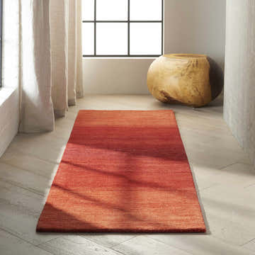 Minimalist room with a Sumac Calvin Klein Linear Glow runner rug on wood floors.