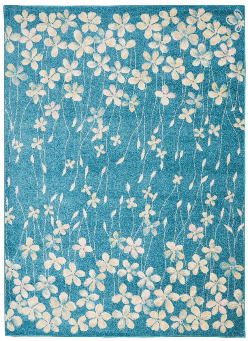 Close-up of the Nourison Tranquil Turquoise rug featuring a floral pattern in cream and aqua on a textured blue background.