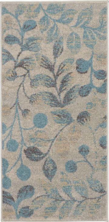 Close-up of the Nourison Tranquil Ivory Turquoise rug with a leafy, botanical pattern in blue, chestnut, and ivory.