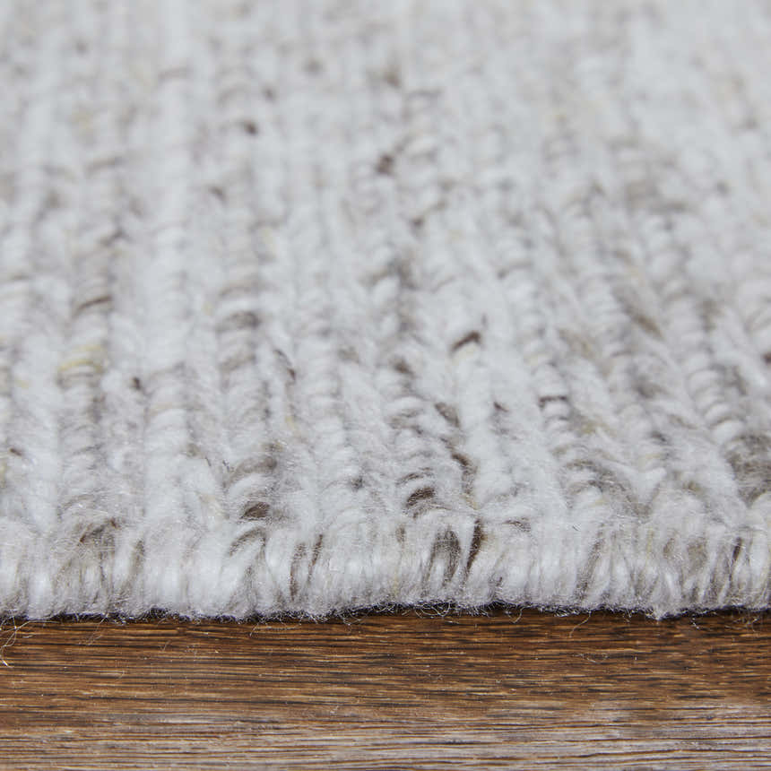 Close-up of the hand-knotted Feizy Finley Modern Solid Silver Area Rug showing texture and color. Pile