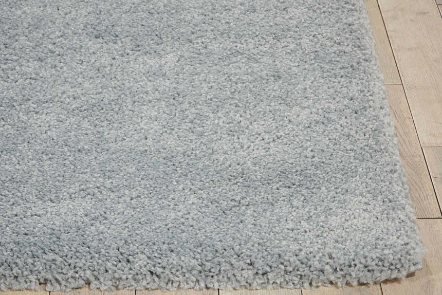 Close-up of the plush texture and slate taupe color of the Nourison Malibu Shag area rug.