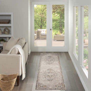Living room scene with a Nourison Antique Fusion ivory and charcoal vintage runner rug. Neutral tones, bright light.