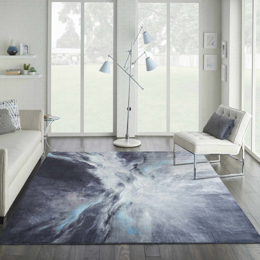 Modern living room with a Nourison Le Reve Charcoal Multicolor rug, white sofa, chair, and large windows.