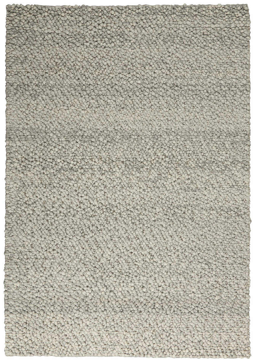Close-up of the Calvin Klein Riverstone rug; a handmade, contemporary rug with a grey and ivory pebble-like texture.