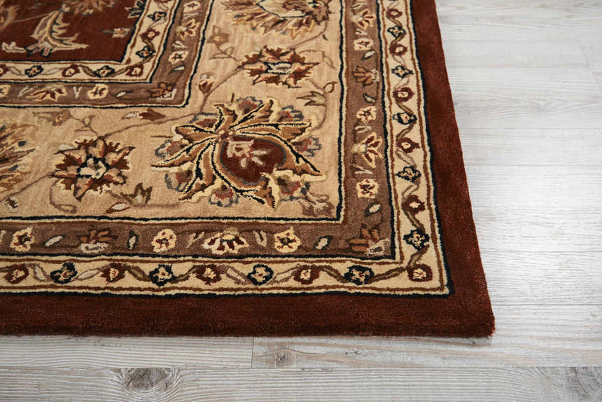 Close-up of the Brick Red Nourison 2000 Persian Rug. Handmade wool rug with floral pattern and intricate border detail.