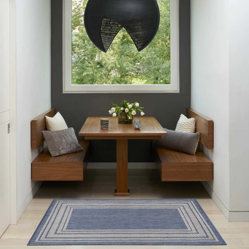 Breakfast nook with wood benches and a Nourison Horizon Denim Modern Area Rug.